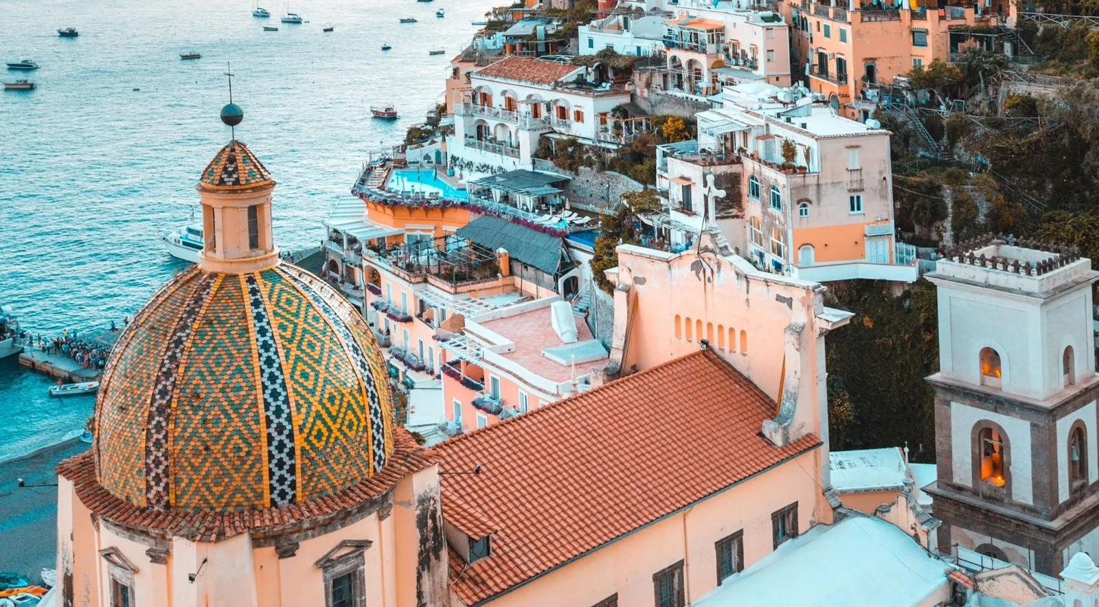 Majolica dome of Santa Maria Assunta among Positano's houses