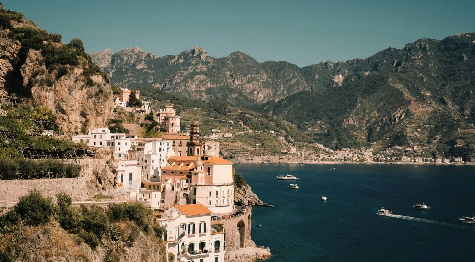 Houses on the cliffs above the sea with the coast mountains behind