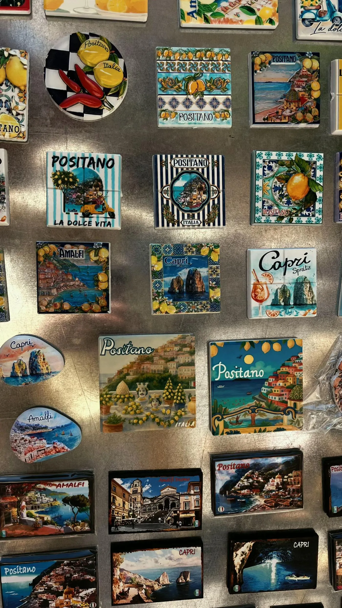 Wall of souvenir fridge magnets showing Positano, Capri and Pompeii