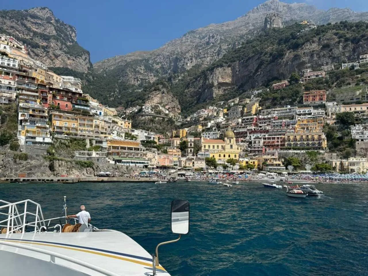 Positano's hillside houses and beach seen from a boat