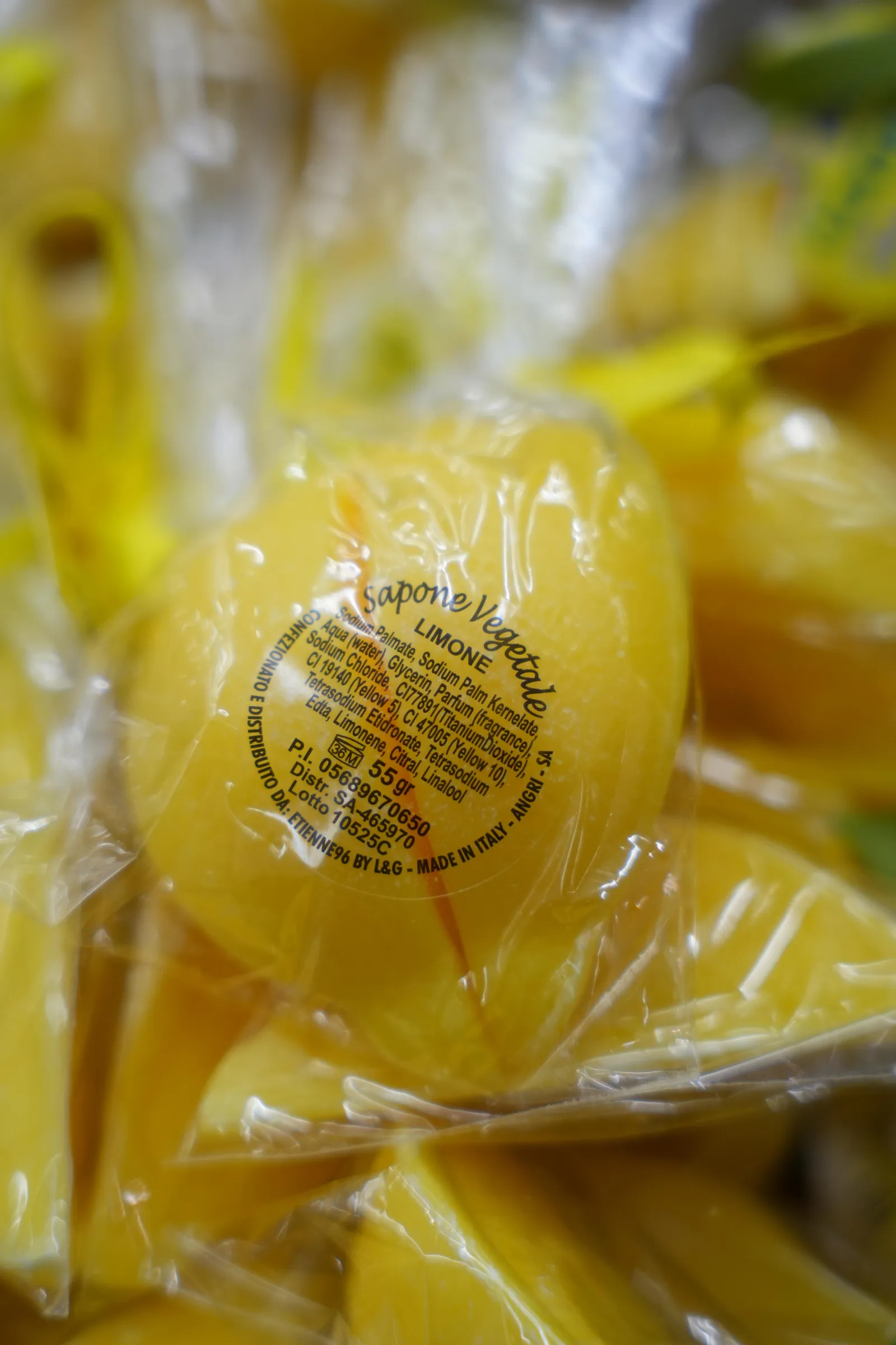 Close-up of lemon-flavoured sweets in yellow wrappers, bagged together